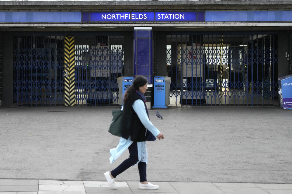 The gates at Northfields tube station are closed as members of the Rail, Maritime and Transport union (RMT) continue nationwide strikes in a bitter dispute over pay, jobs and conditions in London, Friday, Aug. 19, 2022.(AP Photo/Frank Augstein)