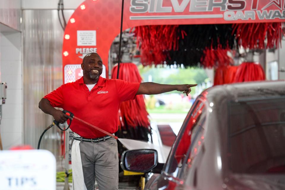 Howard James directs a car through the Silverstar car wash as he sprays down the exterior on Monday, August 23, 2021 on 41st Street in Sioux Falls.