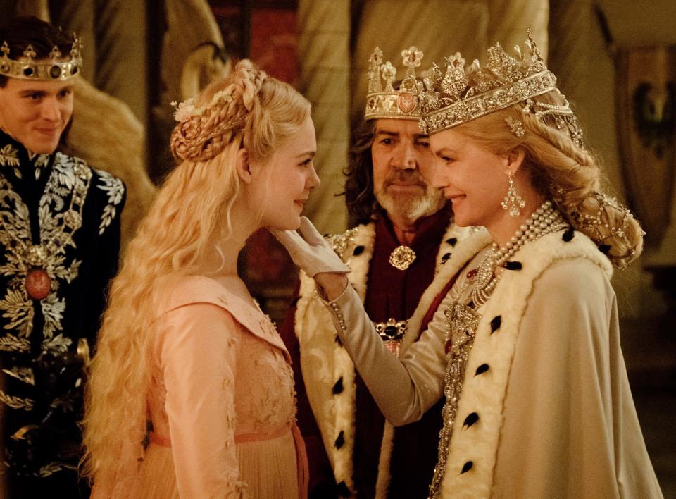 Prince Phillip (Harris Dickinson, left) introduces his fiancée Aurora (Elle Fanning) to dad King John (Robert Lindsay) and Queen Ingrith (Michelle Pfeiffer) in "Maleficent: Mistress of Evil."