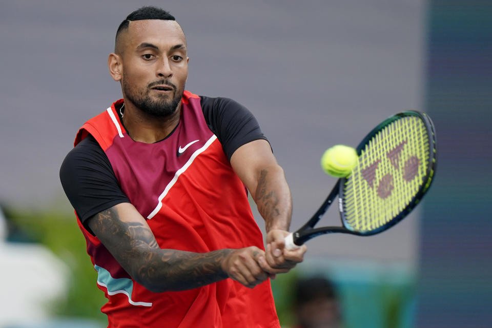 Nick Kyrgios, of Australia, returns a shot from Andrey Rublev, of Russia, during the Miami Open tennis tournament, Friday, March 25, 2022, in Miami Gardens, Fla. (AP Photo/Wilfredo Lee)