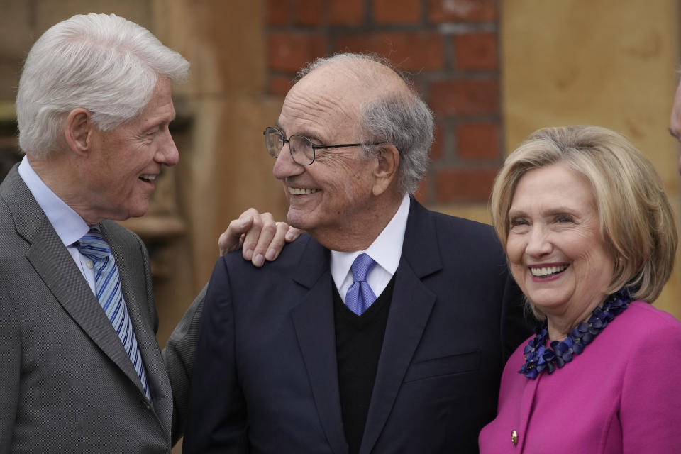 Former US President Bill Clinton, from left, former U.S. Sen. George Mitchell, and former US Secretary of State Hillary Clinton chat on the first day of a three-day international conference at Queen's University Belfast to mark the 25th anniversary of the Good Friday Agreement, in Belfast, Northern Ireland, Monday, April 17, 2023. Former U.S. President Bill Clinton and past leaders of the U.K. and Ireland are gathering in Belfast on Monday, 25 years after their charm, clout and determination helped Northern Ireland strike a historic peace accord. (AP Photo/Christophe Ena)