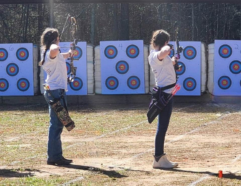 Apple Valley Middle Schol's Aadison Lindsey and Cora Case compete in the archery competition at the district tournament held March 18 in Columbus.