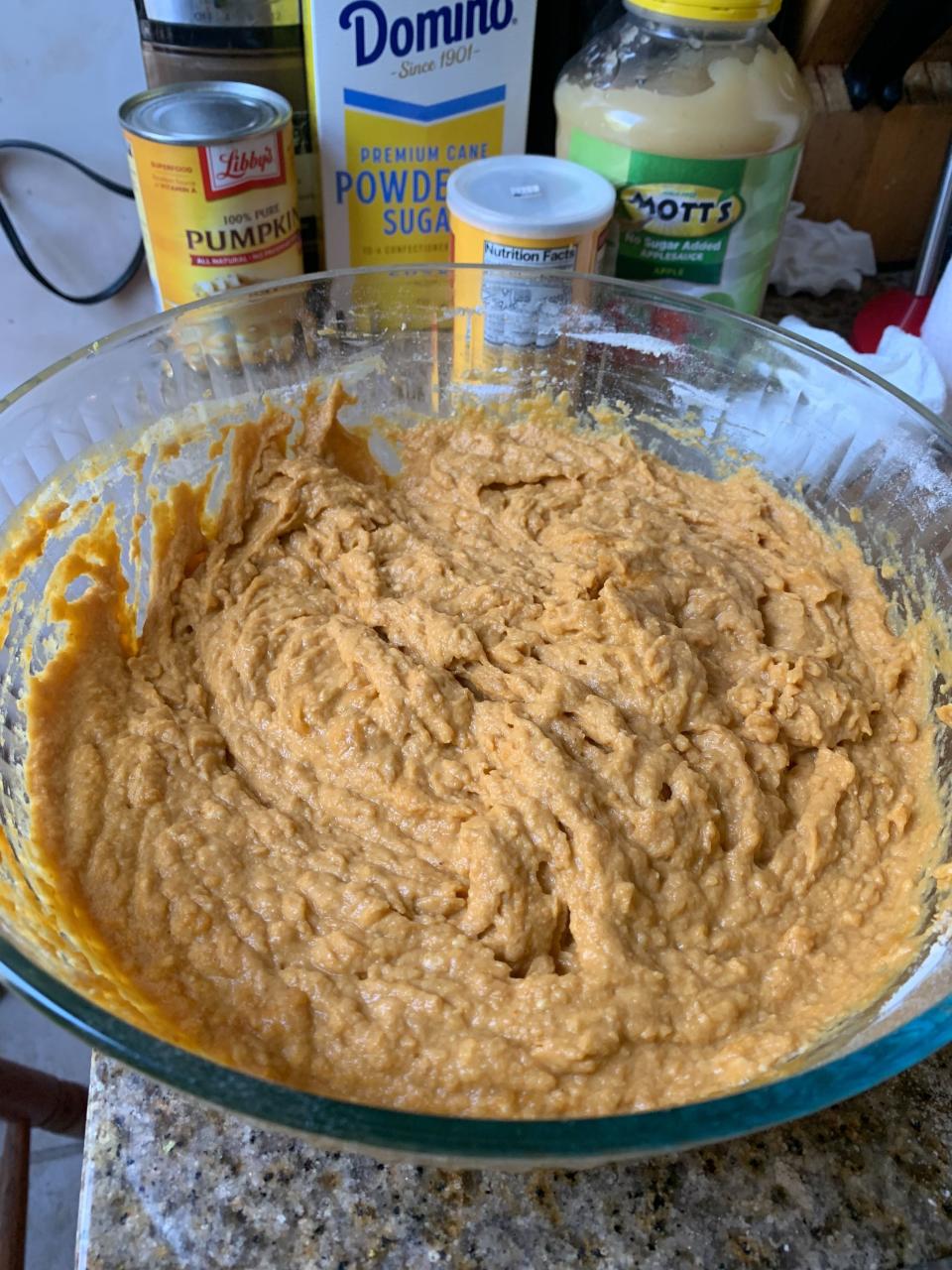 a bowl of pumpkin fritter batter with canned pumpkin, baking powder, applesauce, and lemon zest