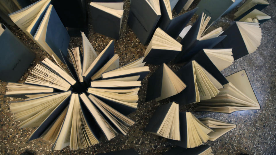 Music books are placed to dry at the first floor of Venice Conservatory after being recovered from ground floor, Italy, Saturday, Nov. 16, 2019. High tidal waters returned to Venice on Saturday, four days after the city experienced its worst flooding in 50 years. Young Venetians are responding to the worst flood in their lifetimes by volunteering to help salvage manuscripts, clear out waterlogged books and lend a hand where needed throughout the stricken city.(AP Photo/Luca Bruno)