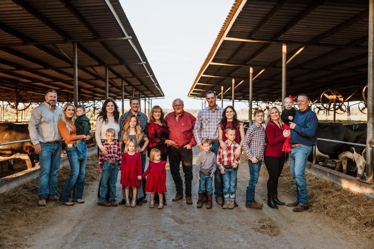 Jerry Dakin has sold the Dakin Dairy Farm to his four nephews, Jason, Garrett, Grant and Ethan, wo are pictured with their father Cameron, their spouses and children.