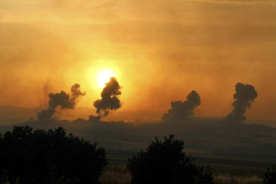 This photo provided Tuesday, May 21, 2019 by the Syrian Civil Defense group known as the White Helmets, shows smoke rising after Syrian government forces targeted the town of al-Habeet, in Idlib province, Syria. Syrian activists and a rebel spokesman said Wednesday, that opposition fighters have recaptured Kfar Nabuda, a village at the edge of the last rebel stronghold in northwestern Syria. (Syrian Civil Defense White Helmets via AP)