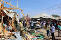 <p>Civilians gather near the scene of a suicide bomb explosion at the Wadajir market in Madina district of Somalia’s capital Mogadishu Feb. 19, 2017. (Photo: Feisal Omar/Reuters) </p>