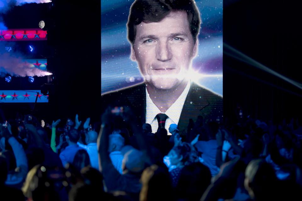 Fans cheer for Tucker Carlson in 2023 before he walks on stage during Turning Point Action general session at the Palm Beach County Convention Center in West Palm Beach.