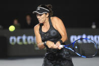 Garbiñe Muguruza, of Spain, returns a shot to Anett Kontaveit, of Estonia, during the final match of the WTA Finals tennis tournament in Guadalajara, Mexico, Wednesday, Nov. 17, 2021. (AP Photo/Refugio Ruiz)