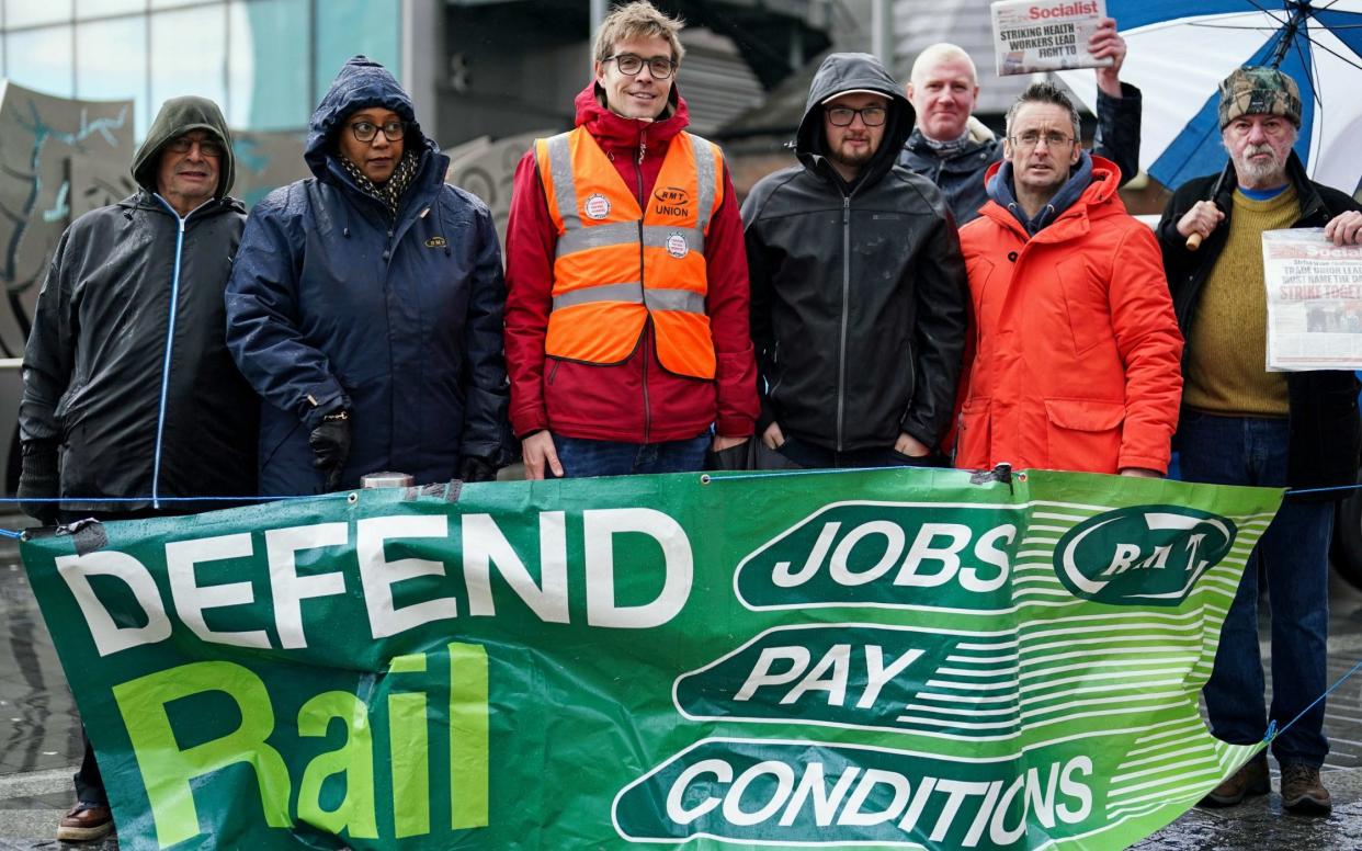 Members of the RMT union on the picket line outside a train station during a rail strike in a long-running dispute over jobs and pensions - Jacob King/PA