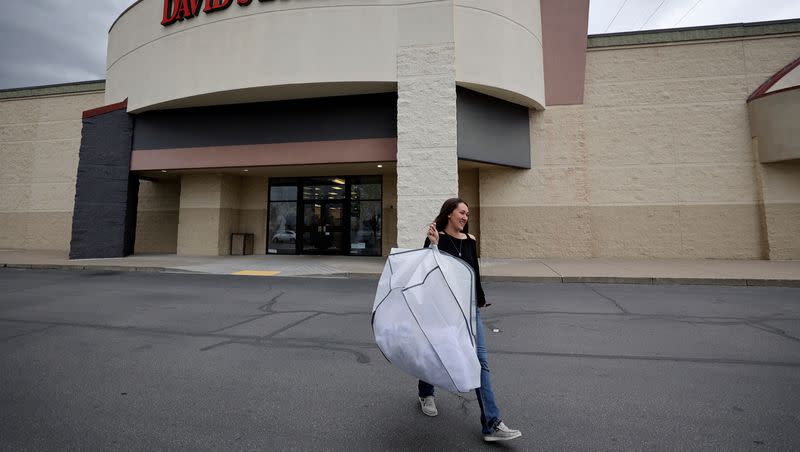 Casy Carrico leaves David’s Bridal after picking up her wedding dress in Salt Lake City on Tuesday, April 18, 2023. The national wedding dress retailer has filed for bankruptcy, though stores remain open, according to reports.