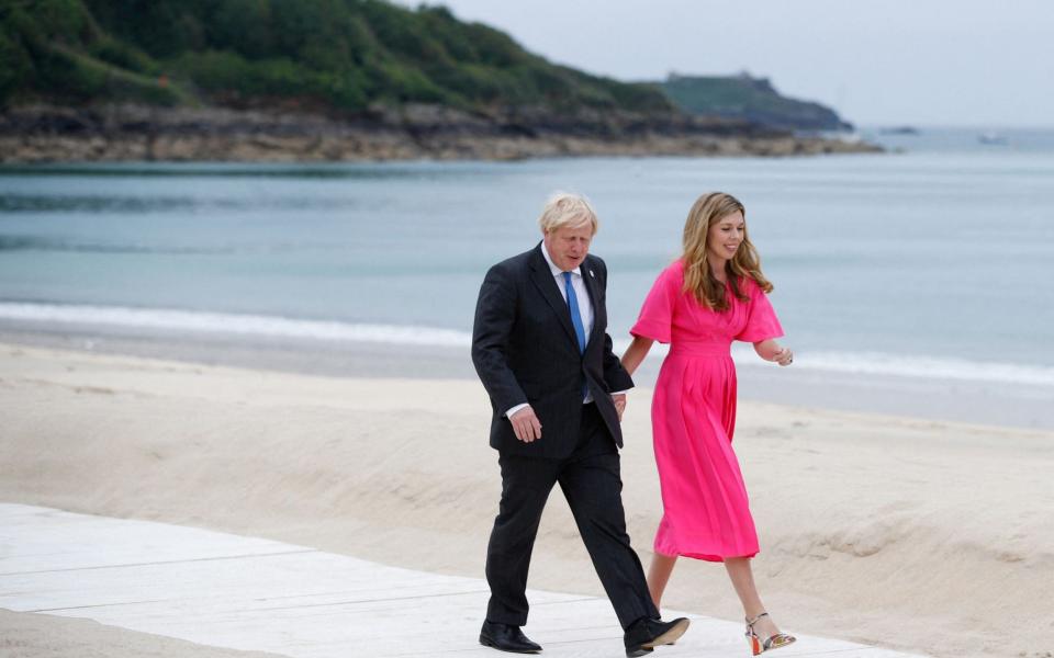 Boris Johnson and his wife Carrie Johnson heading for the 'family photo' - AFP