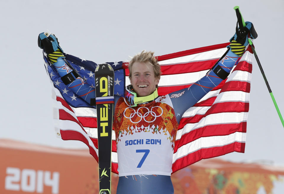 Men's giant slalom gold medalist Ted Ligety of the United States poses for photographers on the podium at the Sochi 2014 Winter Olympics, Wednesday, Feb. 19, 2014, in Krasnaya Polyana, Russia. (AP Photo/Christophe Ena)