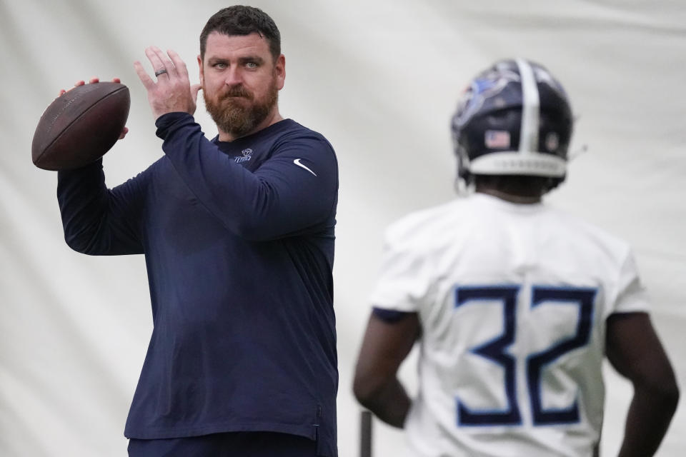 Tennessee Titans offensive coordinator Tim Kelly throws a pass to running back Tyjae Spears (32) during the NFL football team's rookie minicamp, Saturday, May 13, 2023, in Nashville, Tenn. (AP Photo/George Walker IV)