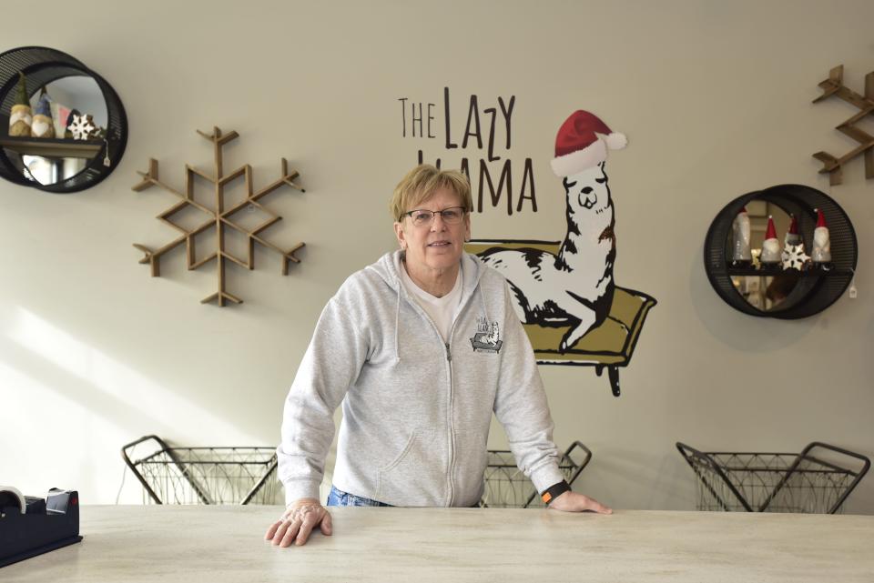 Lazy Llama co-owner Diane Street stands behind the counter of the home décor boutique located at 214 Broadway St. in Marine City on Monday, Dec. 5, 2022. “Who knows what 2023 is going to bring? I don’t know how you can prepare for that. … We just keep going. We just move forward. We just order our inventory and keep our fingers crossed," said Street on the rising costs of inflation and concerns about a future economic recession.