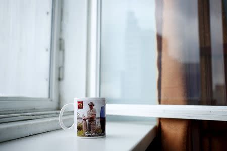 A mug with a picture of Russian President Vladimir Putin is seen in this photo illustration taken in a hotel room in Kazan, Russia, July 31, 2015. REUTERS/Stefan Wermuth