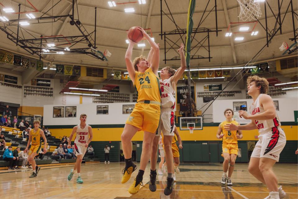 C.M. Russell High’s Dean Blair elevates for a layup in a victory over Kalispell Flathead on Saturday at CMR Fieldhouse.