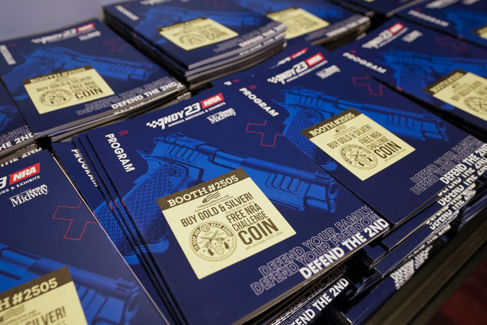 NRA Convention programs are on display at the Indiana Convention Center, Thursday, April 13, 2023, in Indianapolis. The convention starts Friday, April 14 and end on Sunday, April 16. (AP Photo/Darron Cummings)