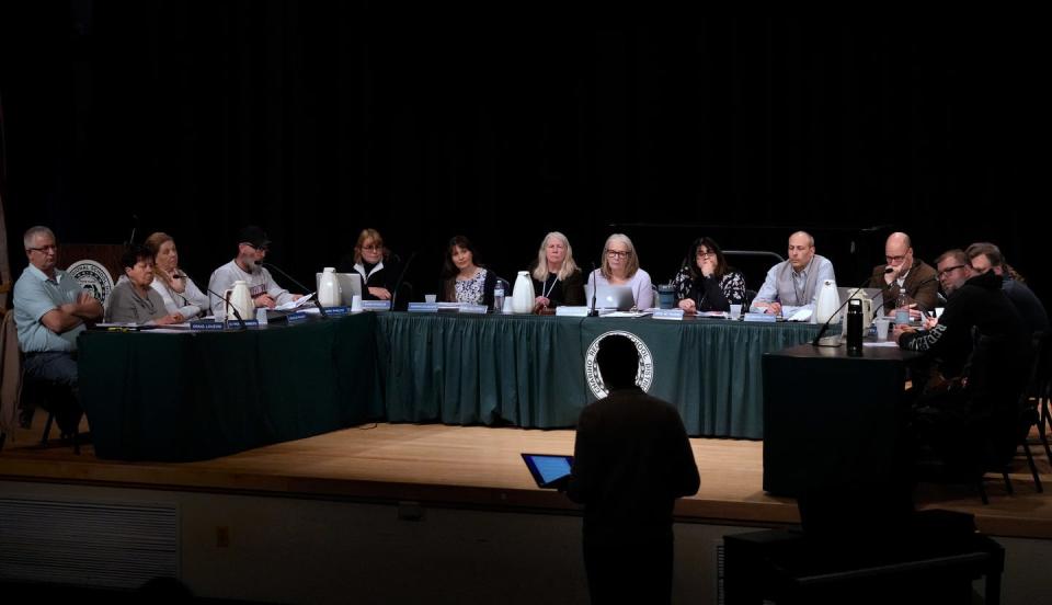 Chariho School Committee members listen during a public speaking portion of a recent school committee meeting at the Chariho Middle school.