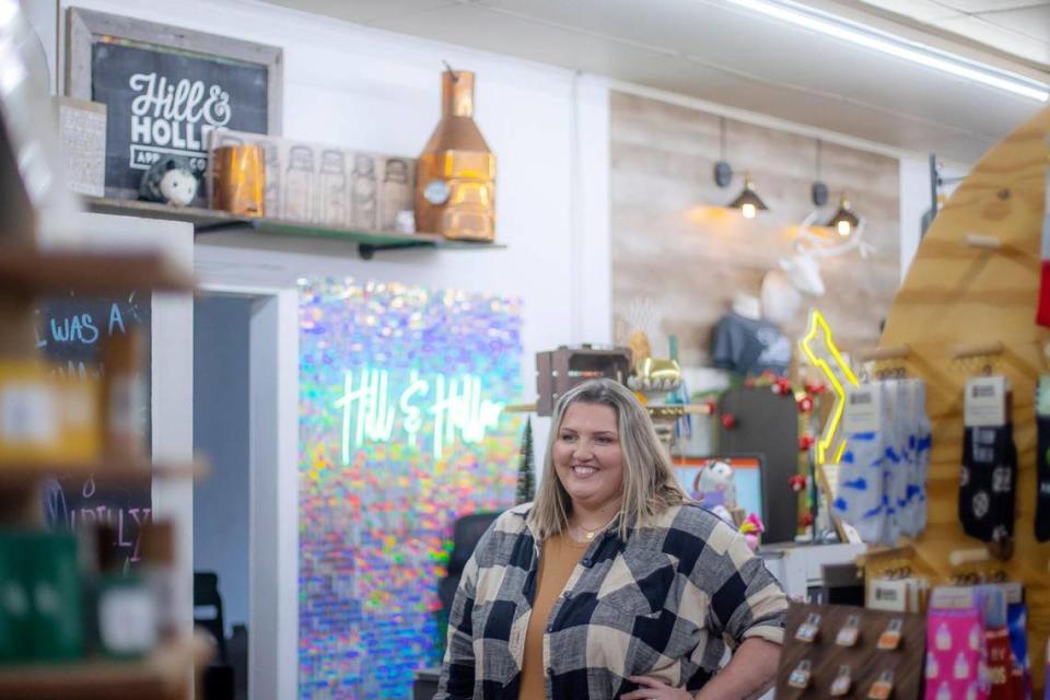 Valerie Long Hinkle poses for a portrait at her store, Hill & Holler, which sells Appalachian-themed T-shirts and gifts in Cumberland, Ky.