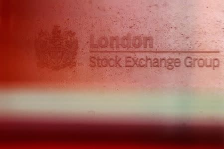 A red London bus passes the Stock Exchange in London February 9, 2011. REUTERS/Luke MacGregor