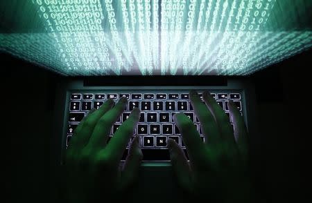 A man types on a computer keyboard in Warsaw in this February 28, 2013 illustration file picture. REUTERS/Kacper Pempel/Files