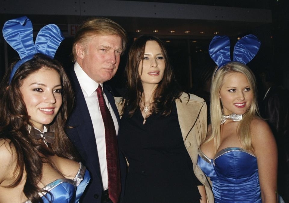 <p>Donald Trump and girlfriend Melania Knauss are joined by a couple of <em>Playboy</em> Bunnies at a launch party for the Hugo Boss store at Fifth Ave. and 56th St. in New York City, circa 2000. (Photo: Richard Corkery/NY Daily News Archive via Getty Images) </p>