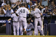 New York Yankees' Tyler Wade, right, greets Anthony Rizzo (48) after Rizzo scored on a single hit by Rougned Odor during the second inning of a baseball game, Saturday, July 31, 2021, in Miami. (AP Photo/Lynne Sladky)