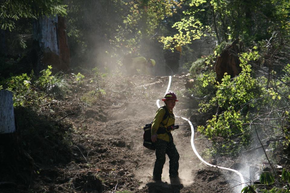 Dozer line on a steep slope has been plumbed with hose to help prepare for tactical firing operations for the Bedrock Fire.