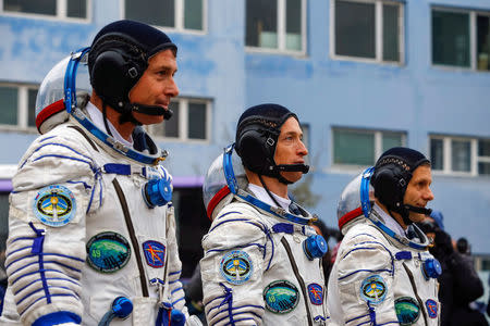 The International Space Station (ISS) crew members Shane Kimbrough of the U.S. and Sergey Ryzhikov and Andrey Borisenko of Russia (L-R) walk after donning space suits at the Baikonur cosmodrome, Kazakhstan October 19, 2016. REUTERS/Shamil Zhumatov