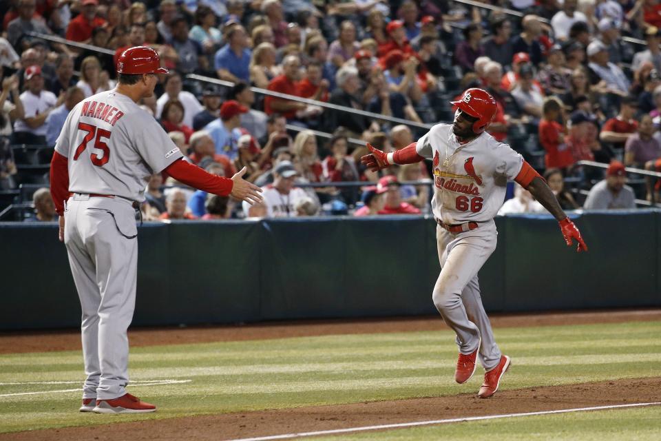 St. Louis Cardinals' Randy Arozarena (66) celebrates his home run against the Arizona Diamondbacks with third base coach Ron Warner during the sixth inning of a baseball game Wednesday, Sept. 25, 2019, in Phoenix. (AP Photo/Ross D. Franklin)