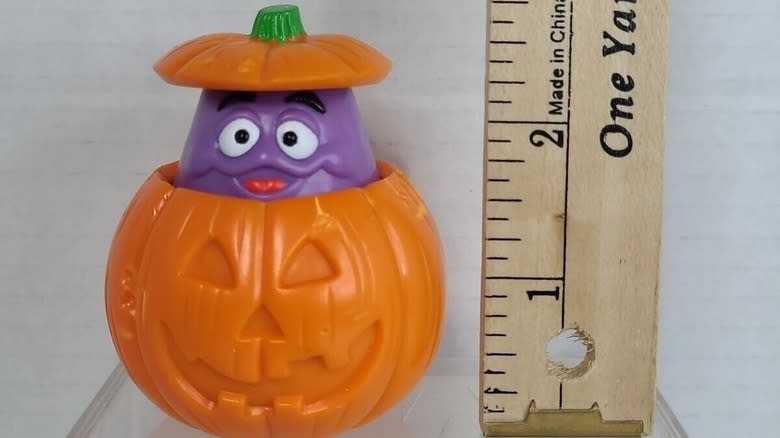 Halloween Grimace beside ruler 