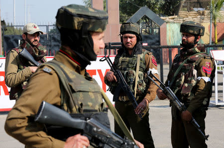 Indian army soldiers stand guard outside an army camp after suspected militants attacked the camp, in Jammu, February 10, 2018. REUTERS/Mukesh Gupta