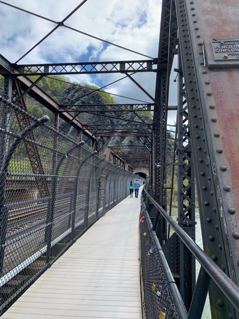Walkers cross a bridge along the Appalachian Trail.
