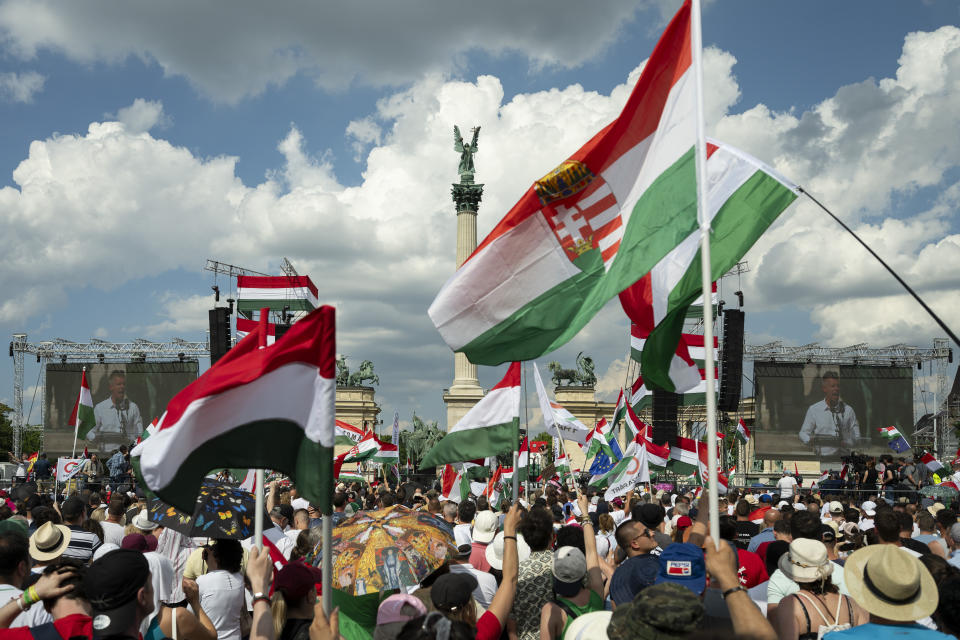 People wave Hungarian national flags during a demonstration, where Péter Magyar, a challenger to Hungarian Prime Minister Viktor Orbán, adresses his supporters on the eve of European Parliament elections on Saturday, June 8, 2024. (AP Photo/Denes Erdos)