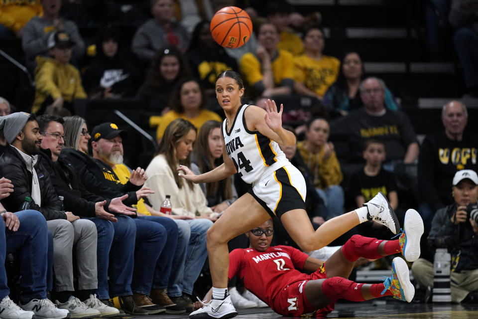 Iowa guard Gabbie Marshall (24) fights for a loose ball with Maryland guard Shyanne Sellers (0) during the second half of an NCAA college basketball game, Thursday, Feb. 2, 2023, in Iowa City, Iowa. (AP Photo/Charlie Neibergall)