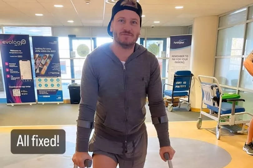 Matthew Wolfenden on crutches in hospital