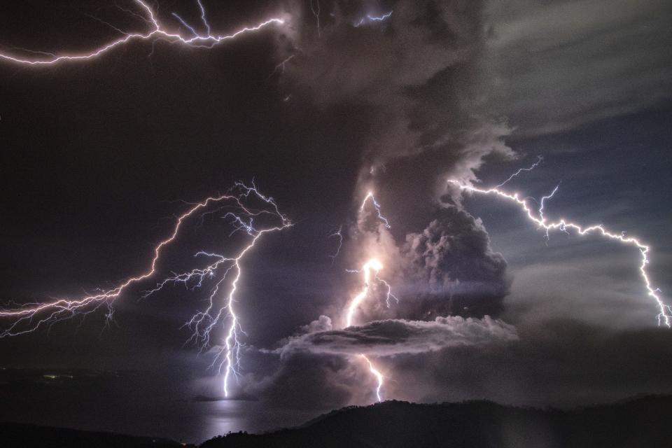 Lightning flares as a column of ash surrounds the crater of Taal Volcano on Jan. 12 in the Philippines.