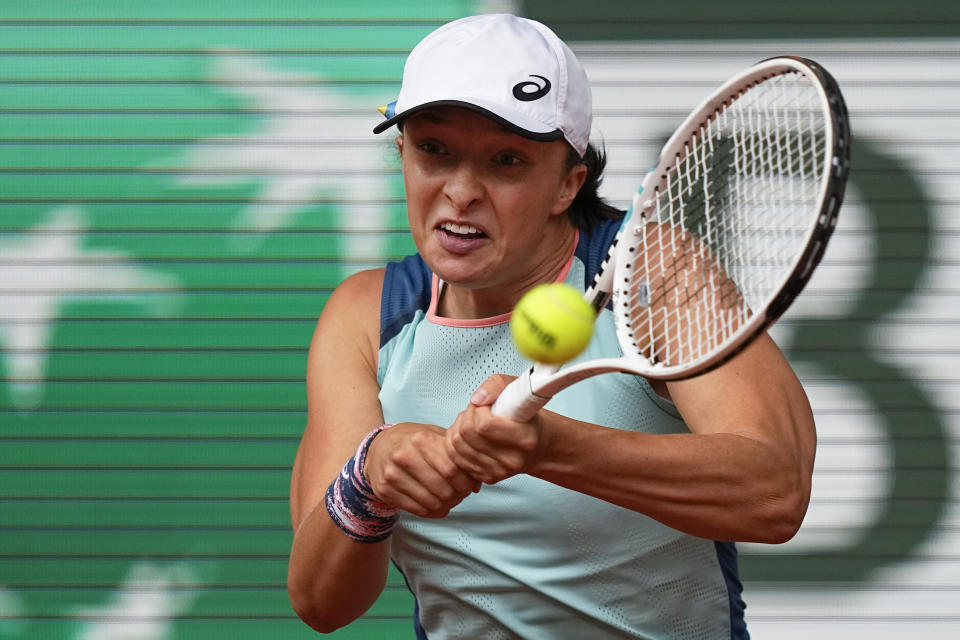 Poland's Iga Swiatek plays a shot against Coco Gauff of the U.S. during the final match at the French Open tennis tournament in Roland Garros stadium in Paris, France, Saturday, June 4, 2022. (AP Photo/Michel Euler)