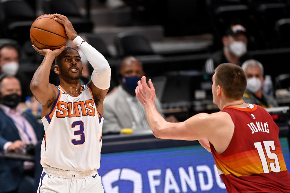  Chris Paul #3 of the Phoenix Suns shoots and scores on a three-point attempt under coverage by Nikola Jokic #15 of the Denver Nuggets in Game Four of the Western Conference second-round playoff series at Ball Arena on June 13, 2021 in Denver, Colorado. NOTE TO USER: User expressly acknowledges and agrees that, by downloading and or using this photograph, User is consenting to the terms and conditions of the Getty Images License Agreement. (Photo by Dustin Bradford/Getty Images)