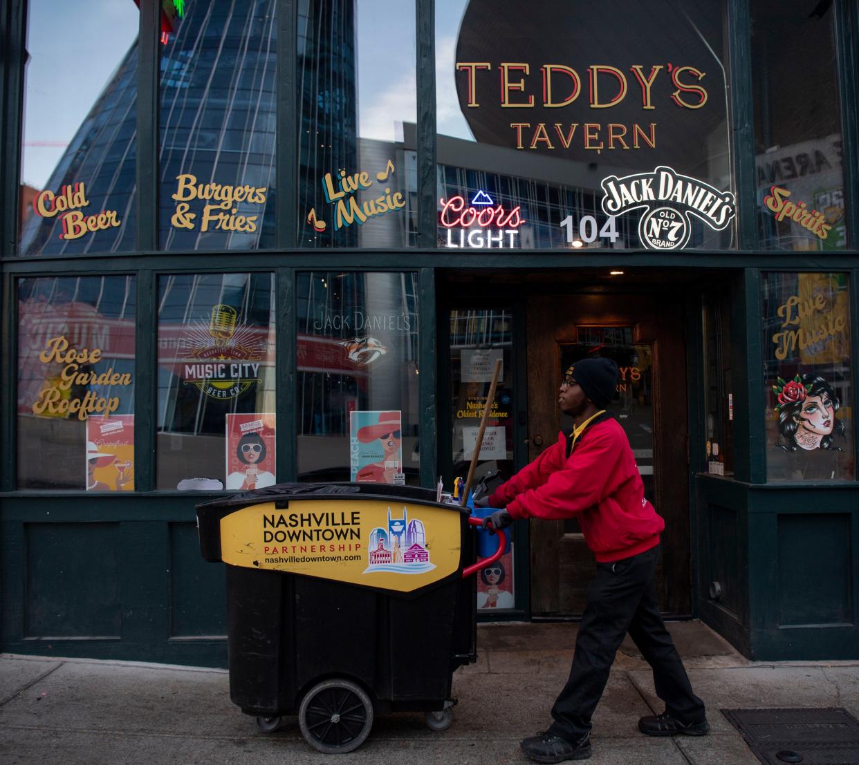 Kaleb Perry cleans the sidewalks in downtown Nashville at dawn on Nov. 13.