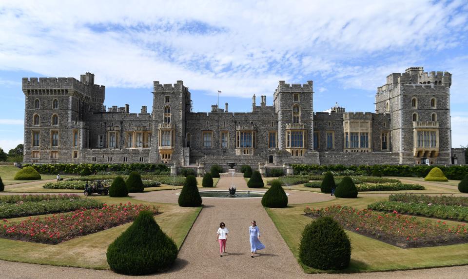 Castle employees pose during a photocall in the East Terrace Garden at Windsor Castle in Windsor on August 5, 2020. - The East Terrace Garden at Windsor Castle will open to visitors at weekends for the first time in decades from August 8. The large formal garden, overlooked by Windsor Castle's east facade, features beds of roses planted in a geometric pattern around a central fountain, and gives views across the surrounding Windsor parkland. The East Terrace Garden was designed for George IV between 1824 and 1826, to provide a pleasant view from his new royal apartments along the east front of the Castle. (Photo by DANIEL LEAL-OLIVAS / AFP) (Photo by DANIEL LEAL-OLIVAS/AFP via Getty Images)