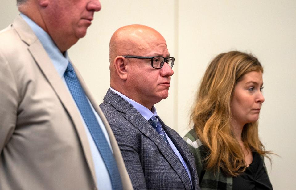 Former Columbus police officer Demetris Ortega stands between his defense attorneys, Mark Collins and Kaitlyn Stephens, on Sept. 14 as he submitted his guilty plea in Franklin County Common Pleas Court to charges in connection with the hit-and run death of a pedestrian, 27-year-old Naimo Mahdi Abdirahman, on April 20, 2022, on Morse Road.