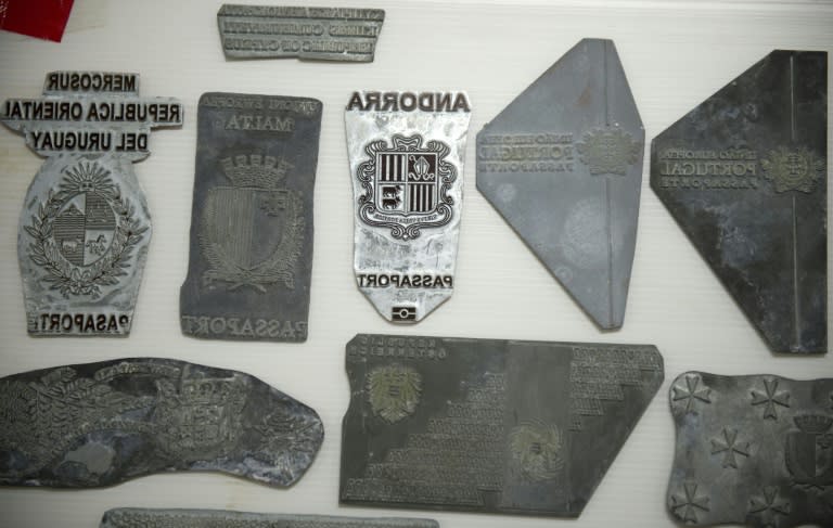 Thai police display counterfeit passport printing plates they recovered from the raid, during a press conference at the immigration bureau in Bangkok