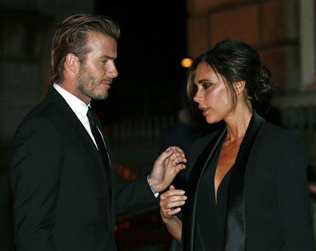 Former England soccer captain David Beckham and his wife Victoria Beckham arrive for a London Fashion Week event to celebrate the Global Fund in London September 16, 2013. REUTERS/Eddie Keogh