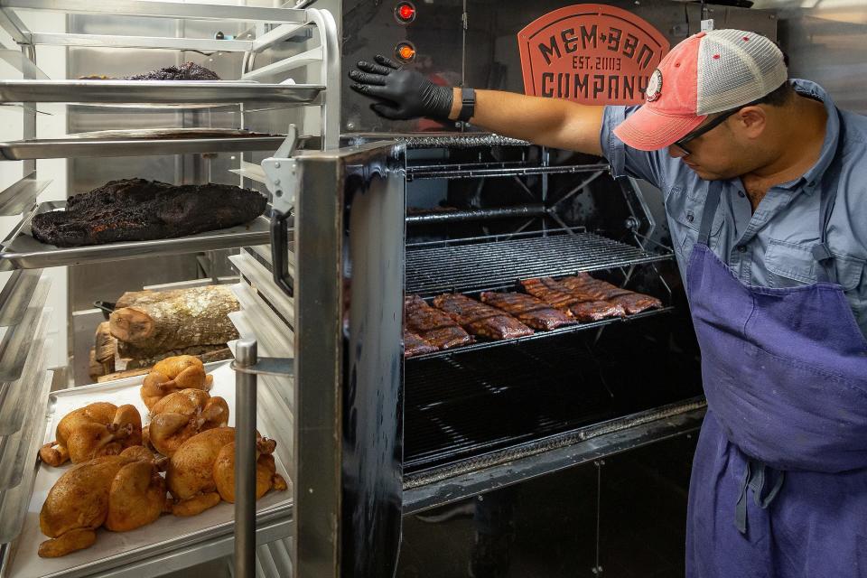 Chef Luis Polanco supervises the smoker at the new Tropical BBQ Market in downtown West Palm Beach.