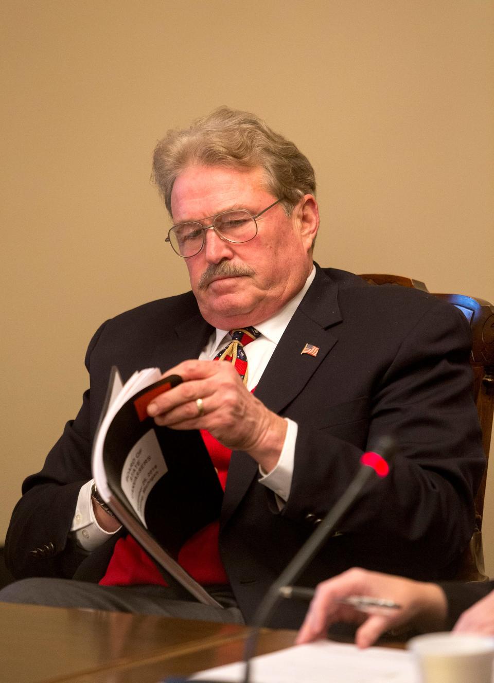 Vice-chair and member of the Board of State Canvassers Norman Shinkle works during a meeting at the Michigan State Capitol building on Nov. 28, 2016, in Lansing.