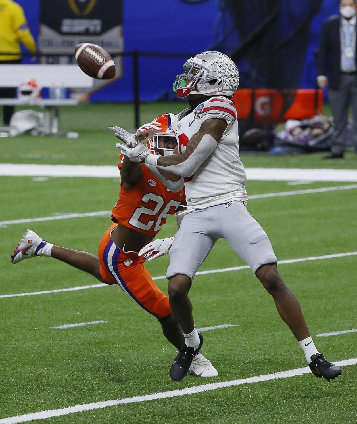 Ohio State Buckeyes wide receiver Jameson Williams (6) catches a 45-yard touchdown catch behind Clemson Tigers cornerback Sheridan Jones (26) during the fourth quarter of the College Football Playoff semifinal at the Allstate Sugar Bowl in the Mercedes-Benz Superdome in New Orleans on Friday, Jan. 1, 2021. Ohio State won 49-28.