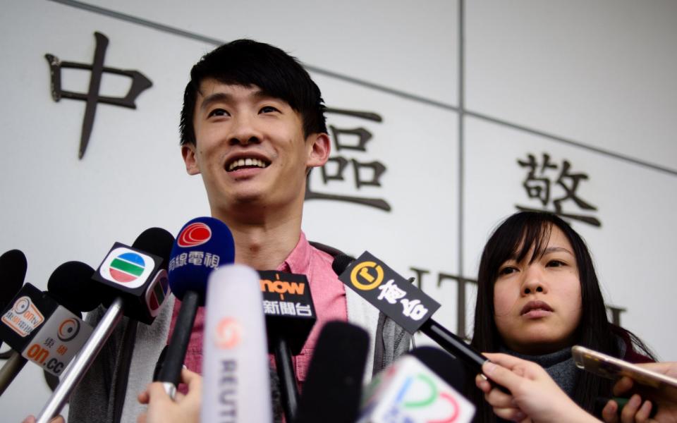 Hong Kong independence activists Yau Wai-ching (R) and Baggio Leung speak to the press after their release from Central police station in Hong Kong on April 26, 2017.  - Credit: Anthony Wallace/AFP