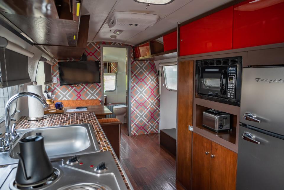 interior of airstream with red cabinets and wood